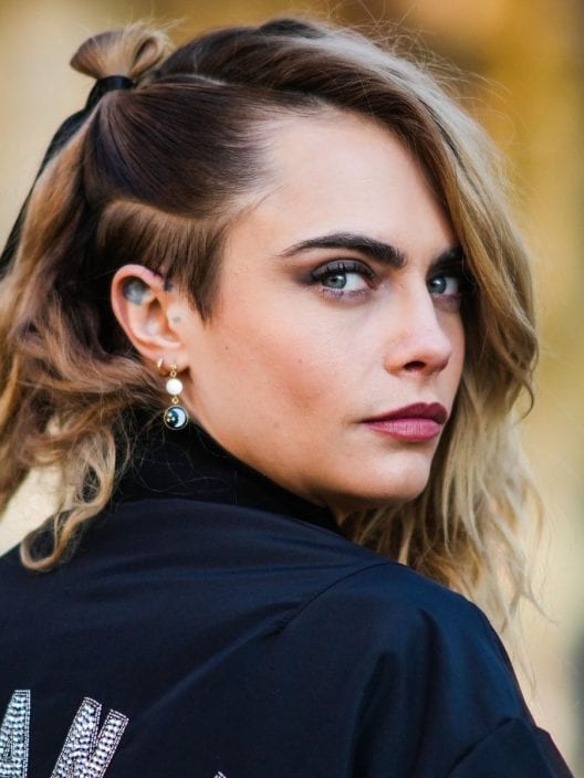 Treccia altissima, colore e grinta: il beauty look di Cara Delevingne per il Pride Month è energia pura